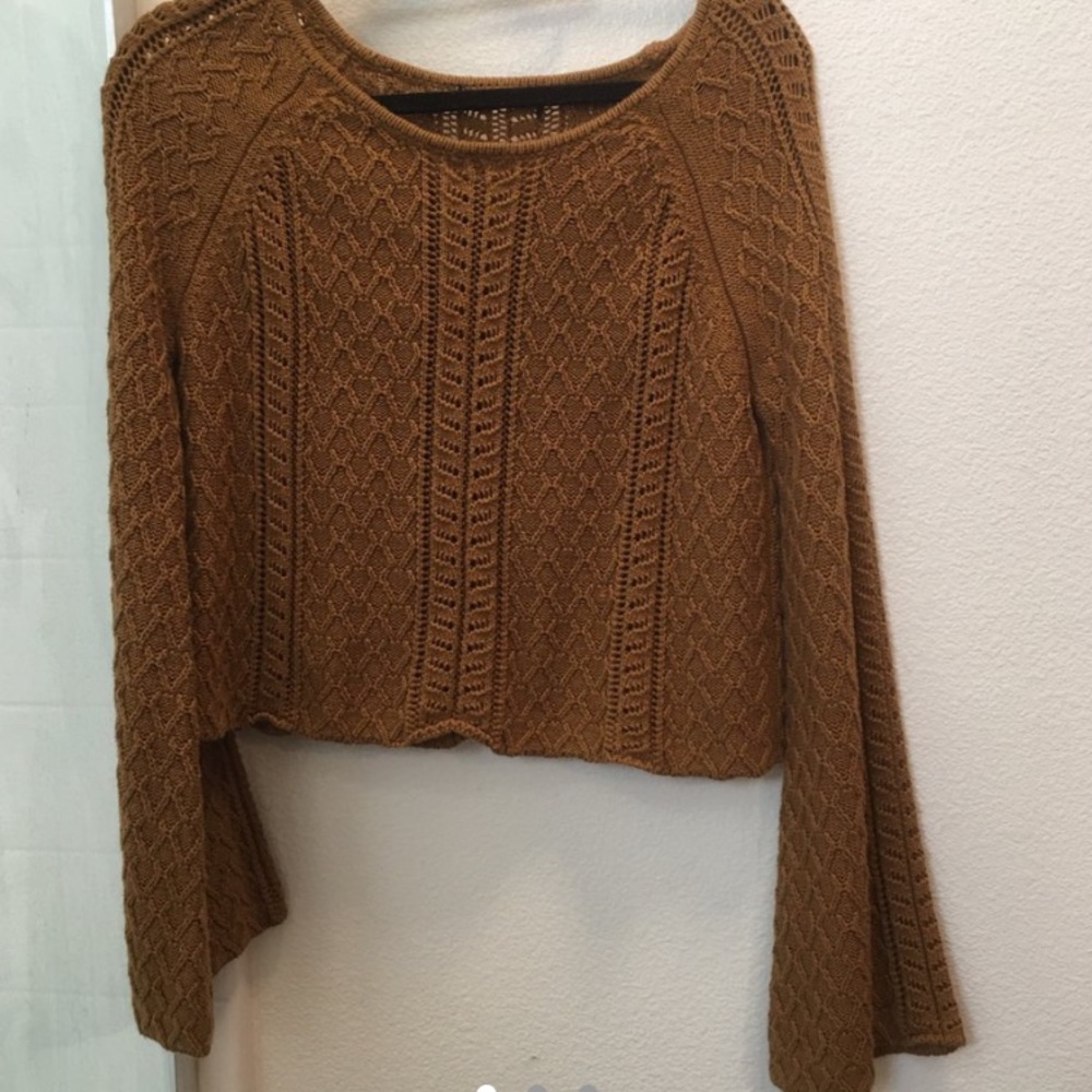 Brown knit crochet sweater with bell sleeves.